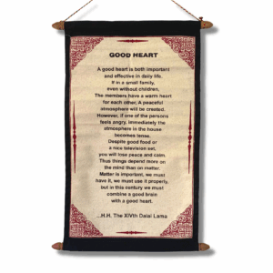 A vertical wall-hanging scroll printed on cream jute-cotton, mounted between two wooden rods, with decorative borders and a Dalai Lama quote about a good heart displayed on textured parchment-style fabric.