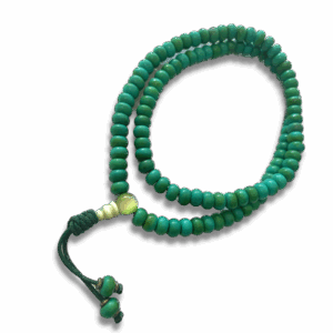 Green faux turquoise mala beads with adjustable cord and tassel-style knot, photographed on a black background.