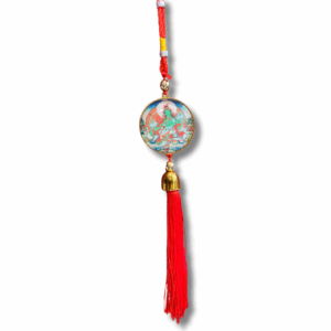 Red tassel hanging ornament with a round medallion depicting Green Tara, braided cord top and gold bell accen