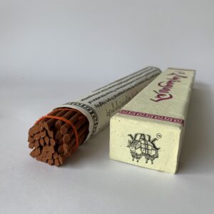 A box of Nagarjuna incense with several sticks visible, tied with orange ribbons and placed against a white background.