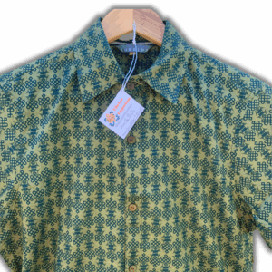 A short-sleeved button-up shirt in green and brown with a floral pattern, displayed on a hanger.