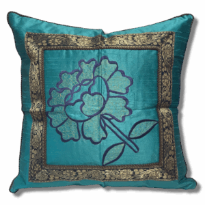 Turquoise blue decorative cushion cover featuring an embroidered floral design in darker blue and gold, framed with ornate gold brocade trim.