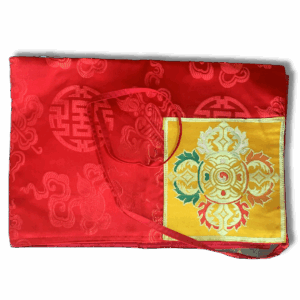 Red Tibetan brocade book or mandala cover decorated with purple dragon motifs and gold auspicious symbols, featuring an inner yellow panel with a multicolour mandala design and red tie straps.