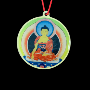 A colorful enameled pendant featuring an image of Buddha Shakyamuni seated in a meditative pose with a Tibetan script mantra on the reverse side.