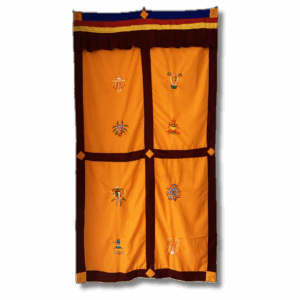 Traditional Tibetan door curtain in golden yellow with maroon borders, featuring eight embroidered auspicious symbols arranged in panels and topped with multicolour trim, designed for hanging at entrances or sacred spaces.