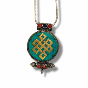 Round Tibetan gau pendant with turquoise inlay featuring a gold endless knot symbol, accented with red and blue stones on a metal setting.