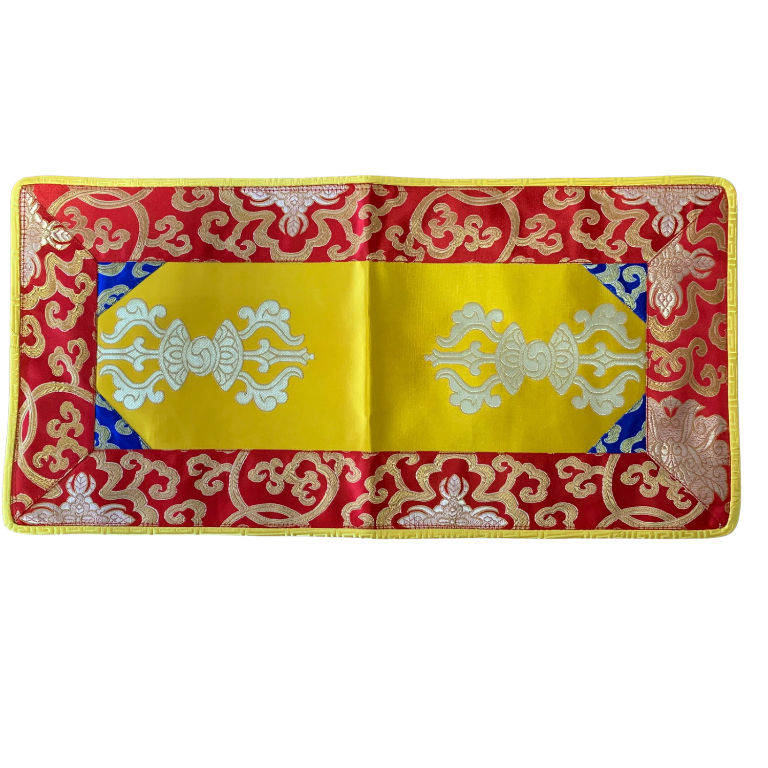 A brocade placemat featuring a yellow surface with red and blue floral brocade patterns and a red or yellow trim.