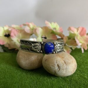 white metal cuff with blue stone
