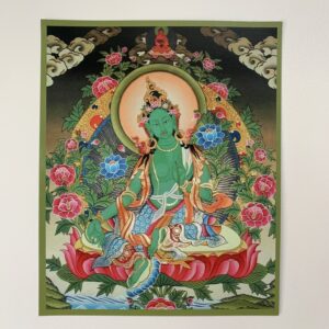 A colorful print of Green Tara, a Tibetan Buddhist deity, seated amidst floral patterns on a card.