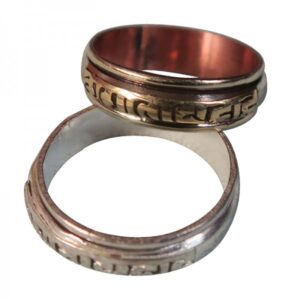 A two-tone (gold and silver) Rotatable Sanskrit Mani Mantra ring, displayed in a stacked position with the top ring slightly shifted to reveal the band below.