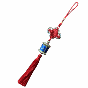 Red knot prayer wheel hanging charm featuring a blue metal miniature prayer wheel with engraved mantra symbols and a red tassel, suitable for hanging on bags, car mirrors or altars.