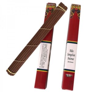 A package of Ribo Sangchoe Tibetan incense with several sticks visible outside the package. The packaging is primarily red with multicolor details and text.