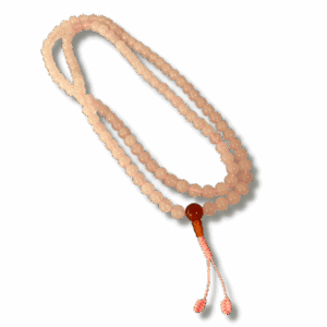 A Rose Quartz 108 Prayer Bead Mala with a pink bead and a red tassel against a black background.