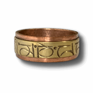 Rotatable Tibetan mantra ring made from brass and copper, engraved with sacred script for meditation and mindfulness.