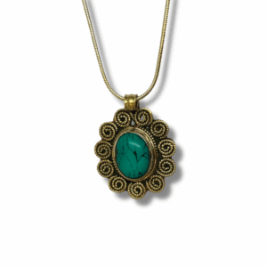 Brass-tone pendant necklace featuring an oval turquoise stone set in an ornate Tibetan-style filigree frame, hanging from a fine chain on a white background.