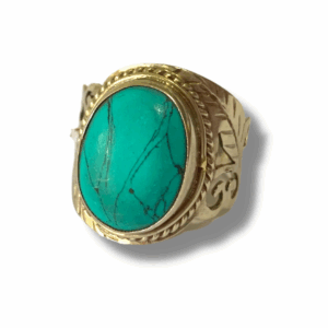 Silver-tone Tibetan style ring featuring a large oval turquoise howlite stone with dark natural veining set in an engraved metal band.
