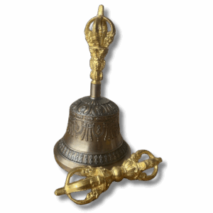 Tibetan vajra and bell set in brass, featuring an engraved ritual bell with ornate handle and matching double vajra used in Buddhist practice.