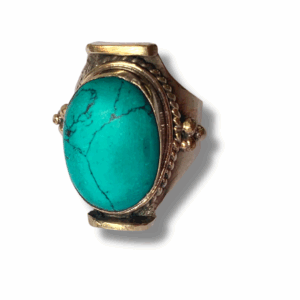 Large oval turquoise stone cuff ring in silver-tone metal setting with ornate Tibetan-style detailing, handmade jewellery.